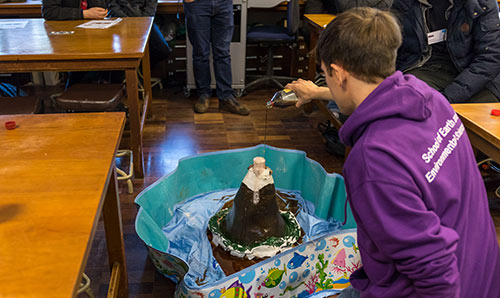 A male school pupil performing a volcano experiment
